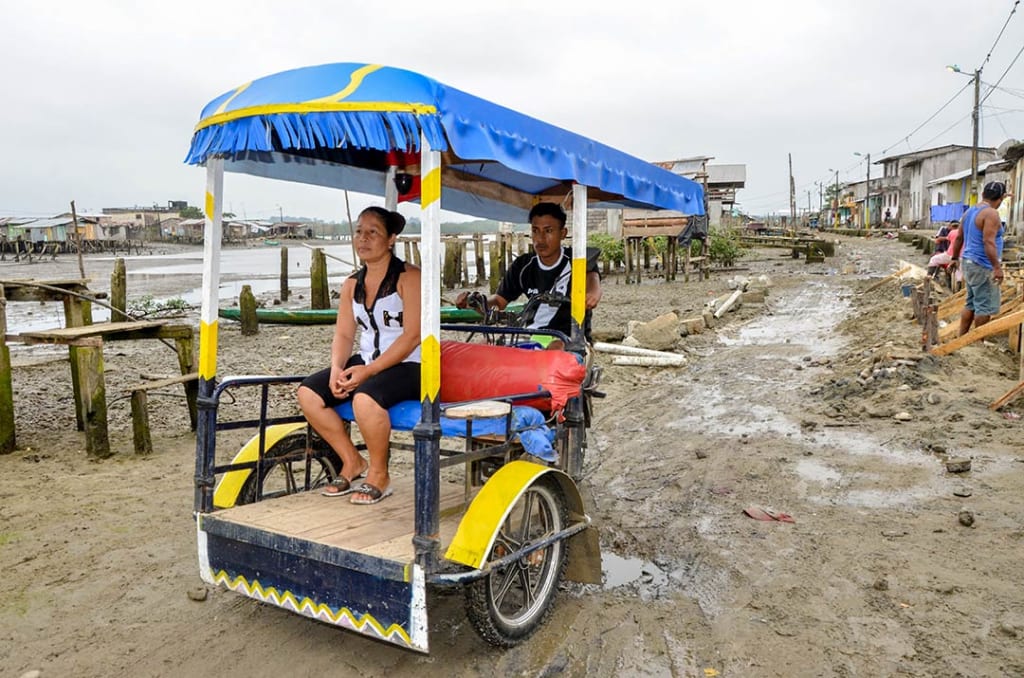 Dastin’s dad, Miguel, at work transporting people on his moto-tricycle.